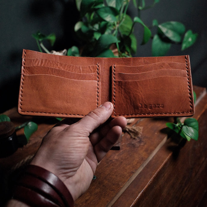 Elegant saddle tan leather bifold wallet with functional design
