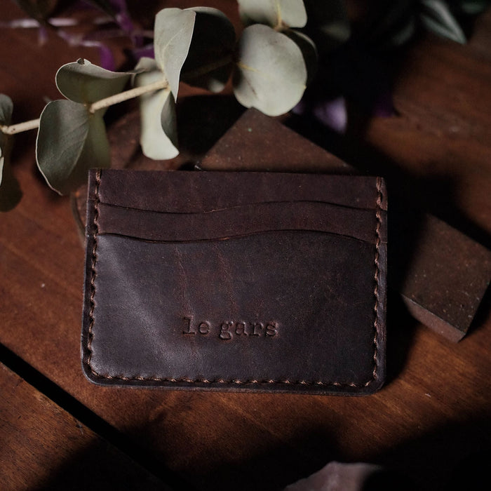 Full-grain dark-brown leather wallet with slim minimalist design
