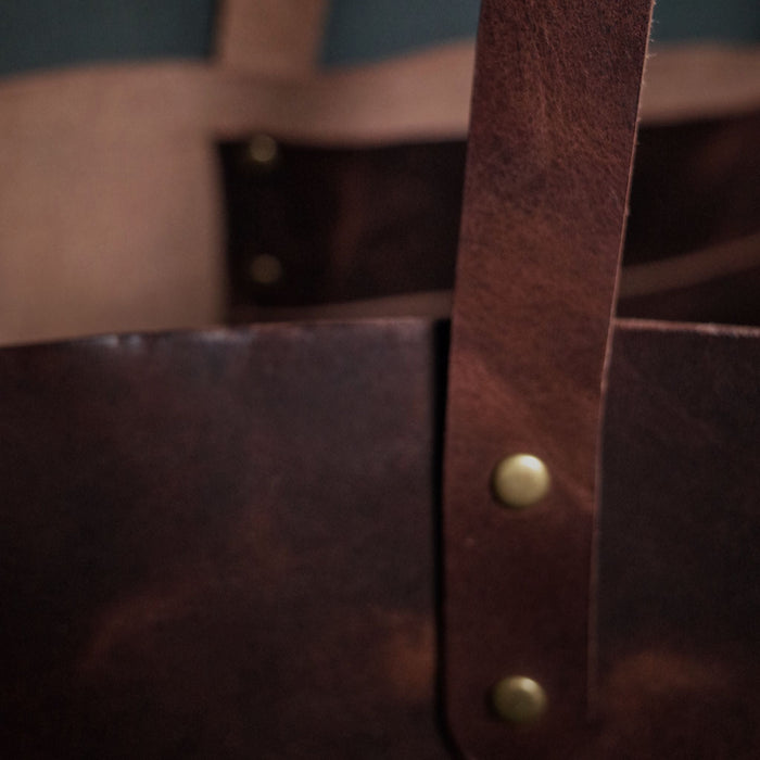 Classic dark-brown leather tote for carrying your daily essentials
