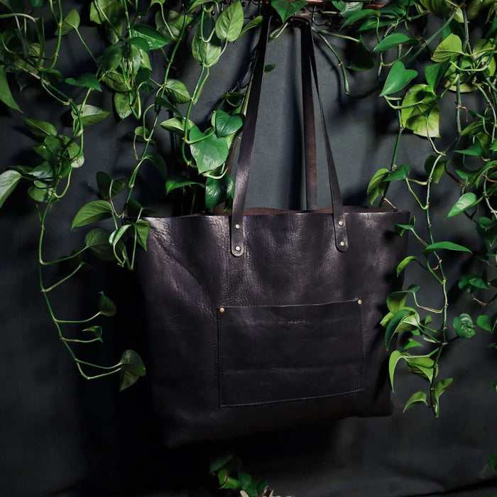 Minimalist full-grain black leather tote for everyday use
