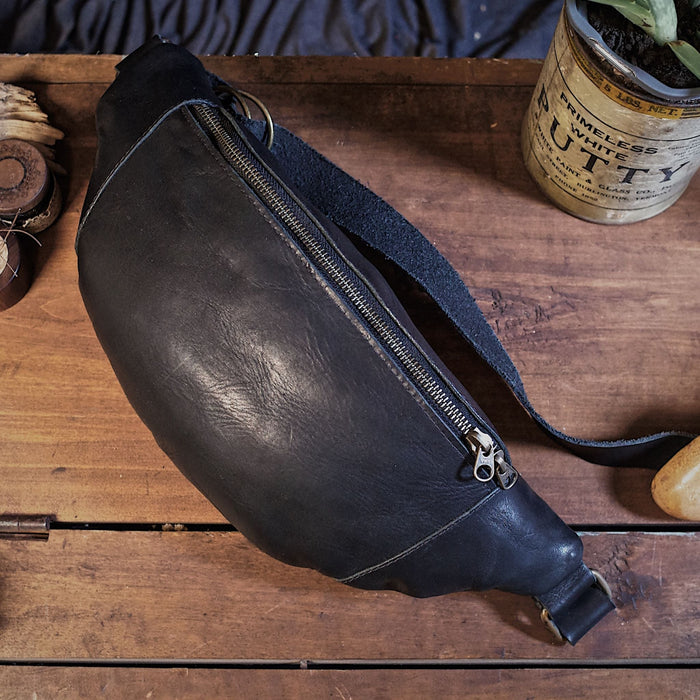 Hand-stitched black leather fanny pack with oversized design
