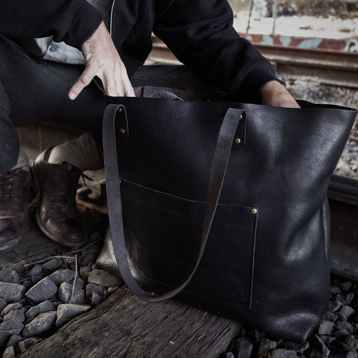 Locally crafted black leather tote with custom engraving options
